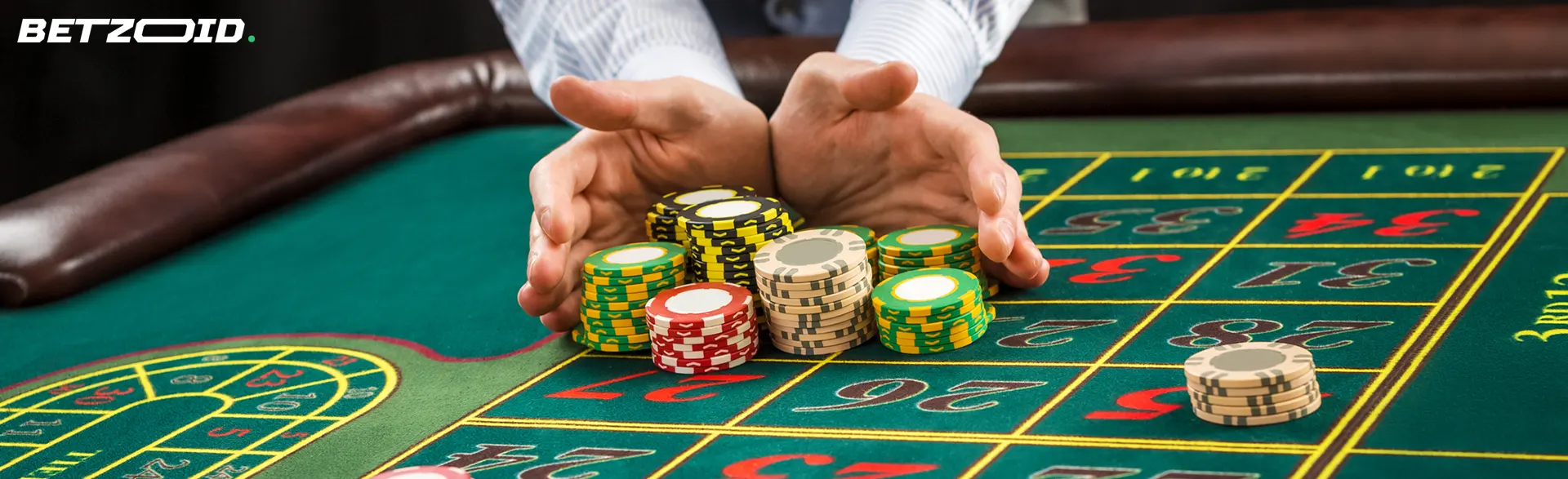 The player collects winning chips on the roulette wheel.