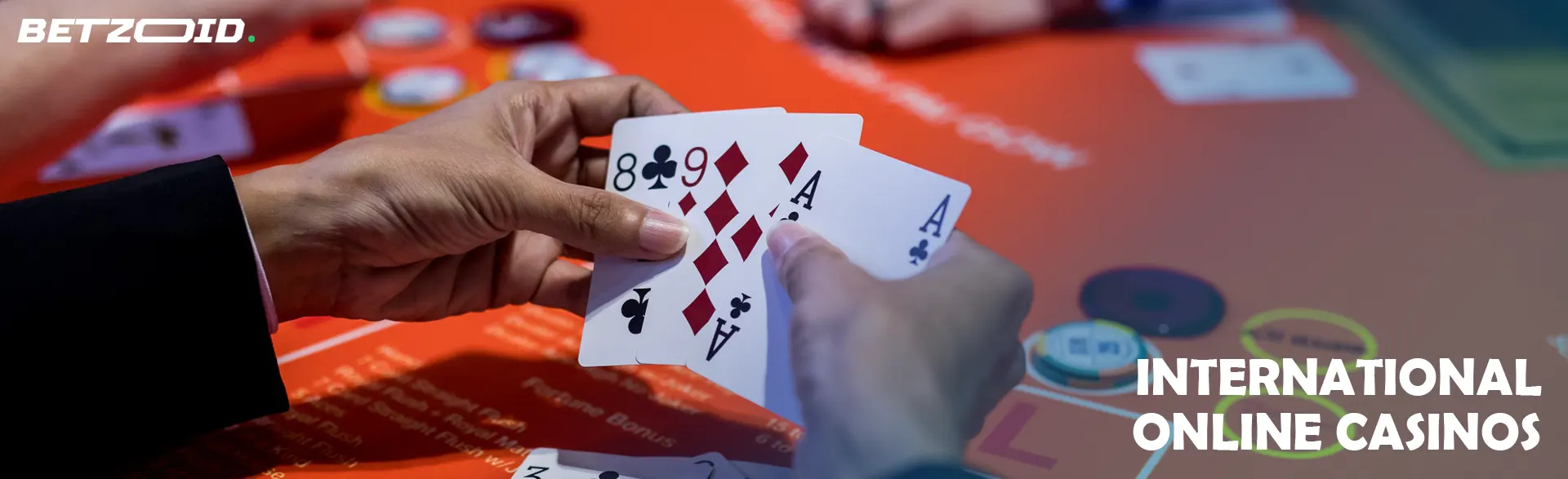 A player holds cards over a casino table.