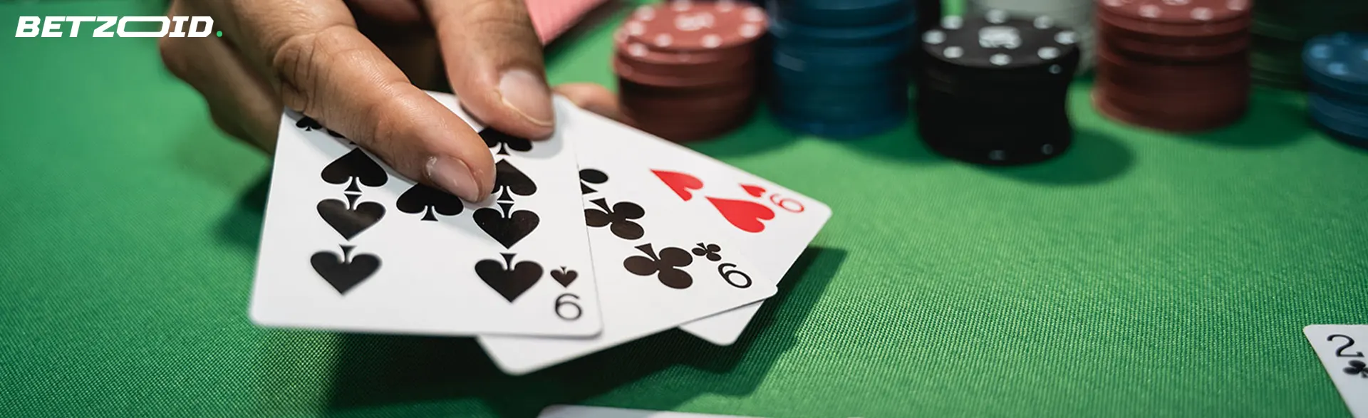 The player holds cards on the table with chips.