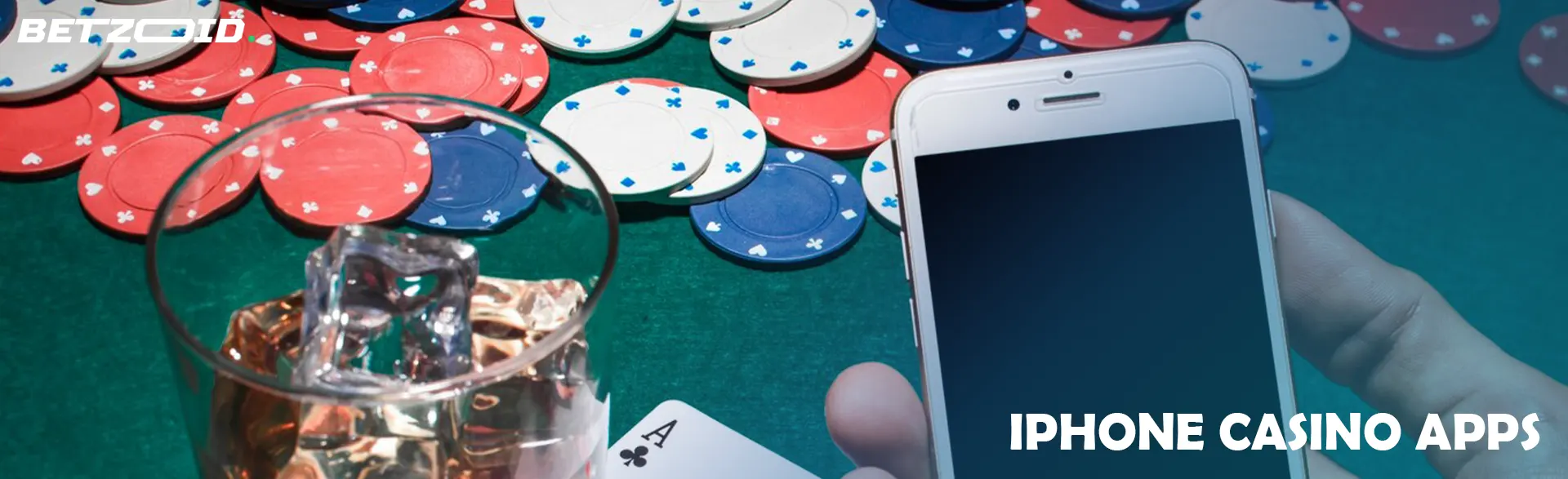 The player is holding a smartphone and a drink in a glass on the background of casino chips.