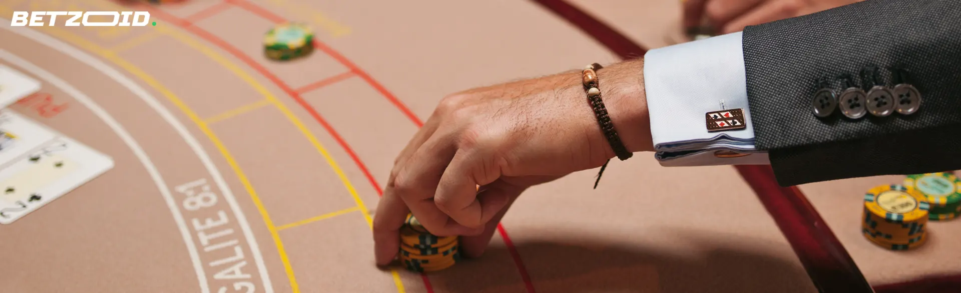A player's hand puts chips on the casino table.