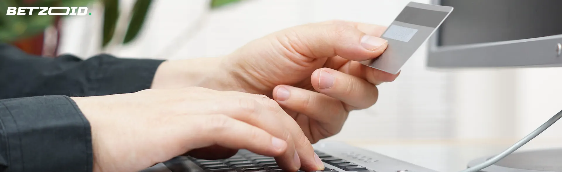 Man enters bank card details on keyboard.