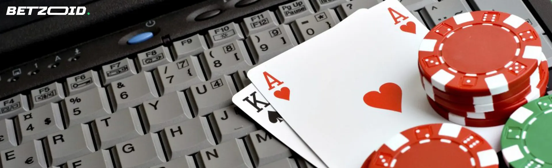 Cards and casino chips on the keyboard.